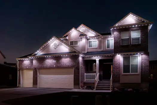 Home with permanent holiday lighting at night